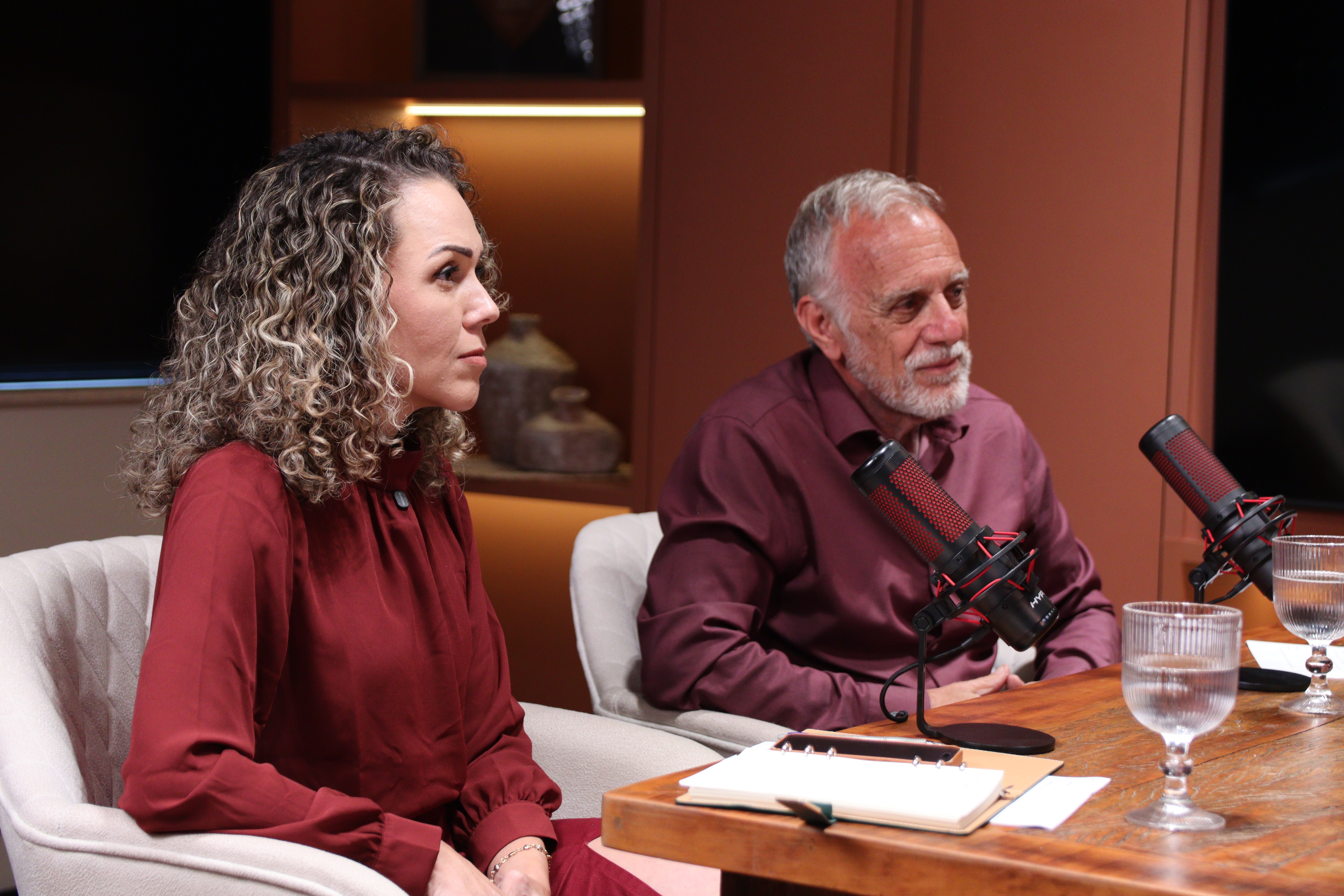 Marcos e Fernanda, âncoras de O Lado B dos Negócios, na mesa do podcast